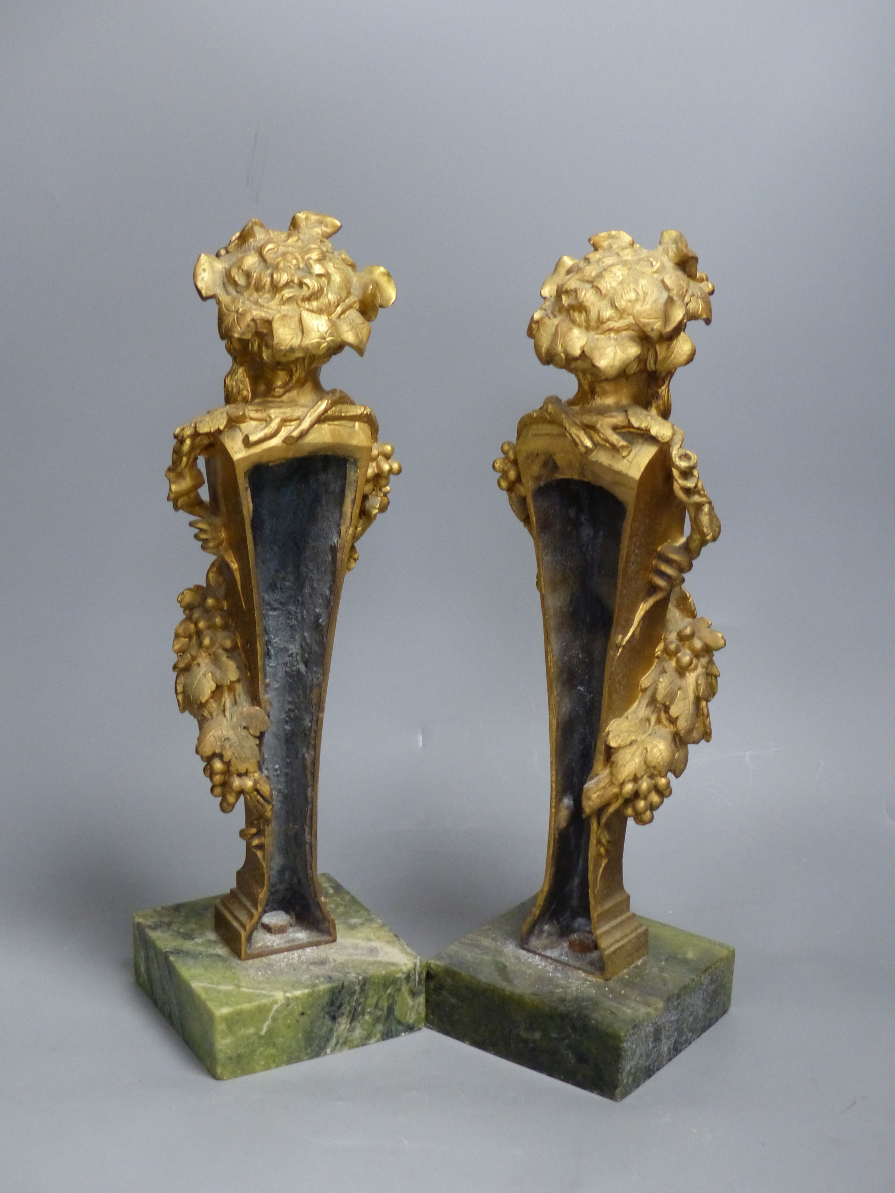 A pair of gilt bronze 'Bacchus' mounts, on Connemara marble bases, height 40cm